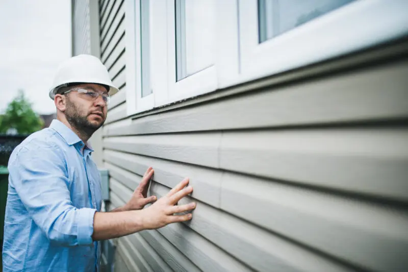 Man Fixing Siding
