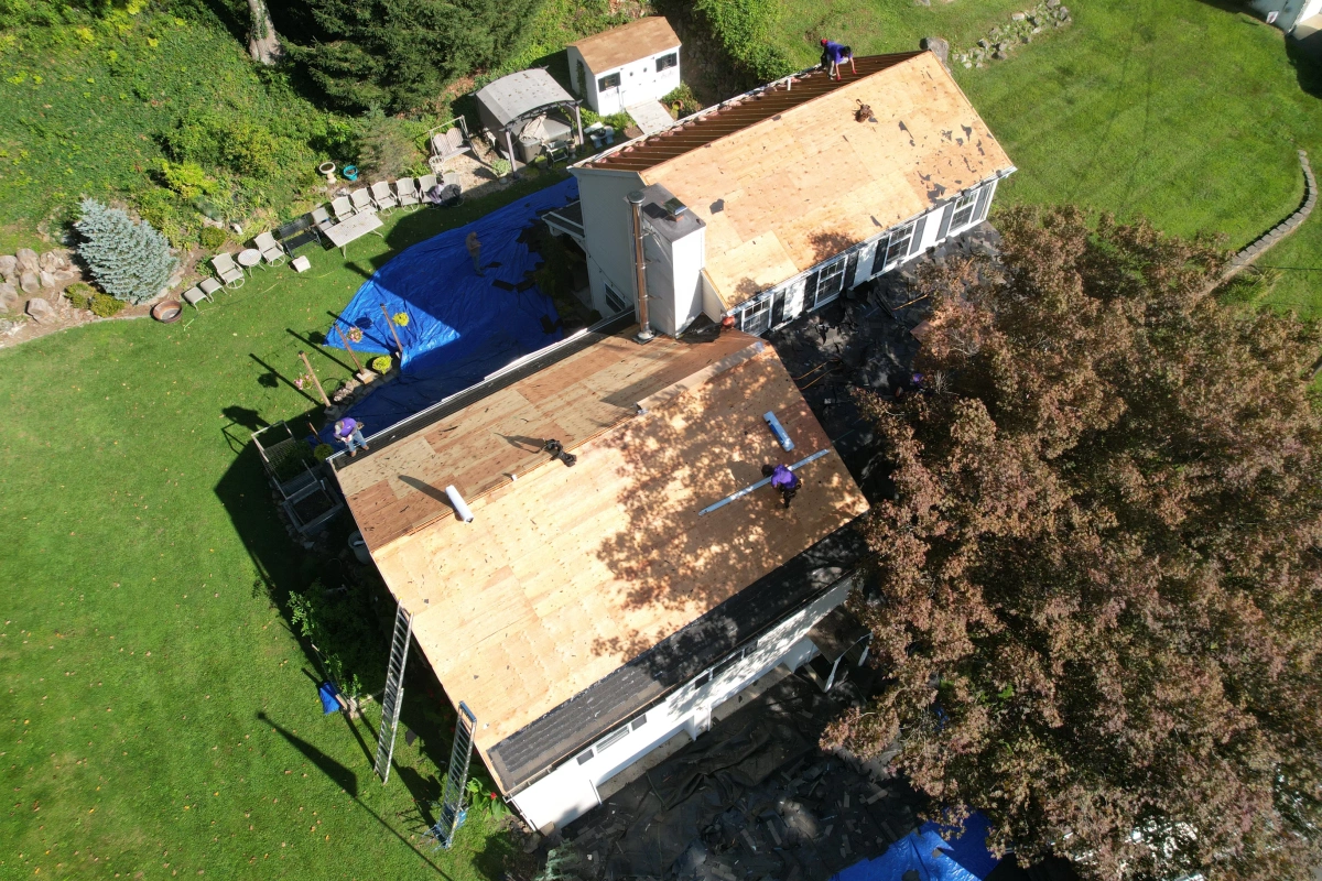 Roofers replacing asphalt shingle roof on New Jersey home