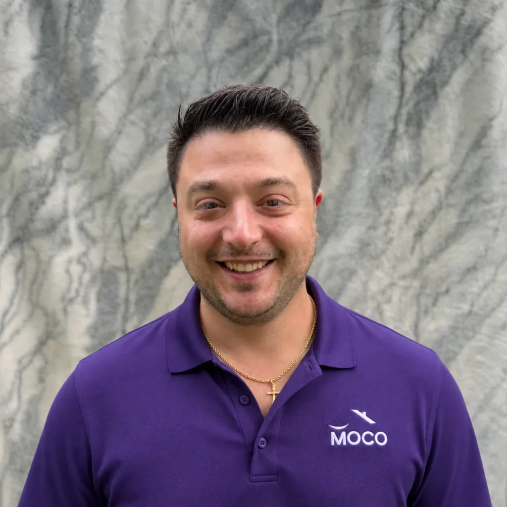 Jonathan Hargadon owner of Morris County Roofing and Siding wearing a purple MOCO polo shirt
