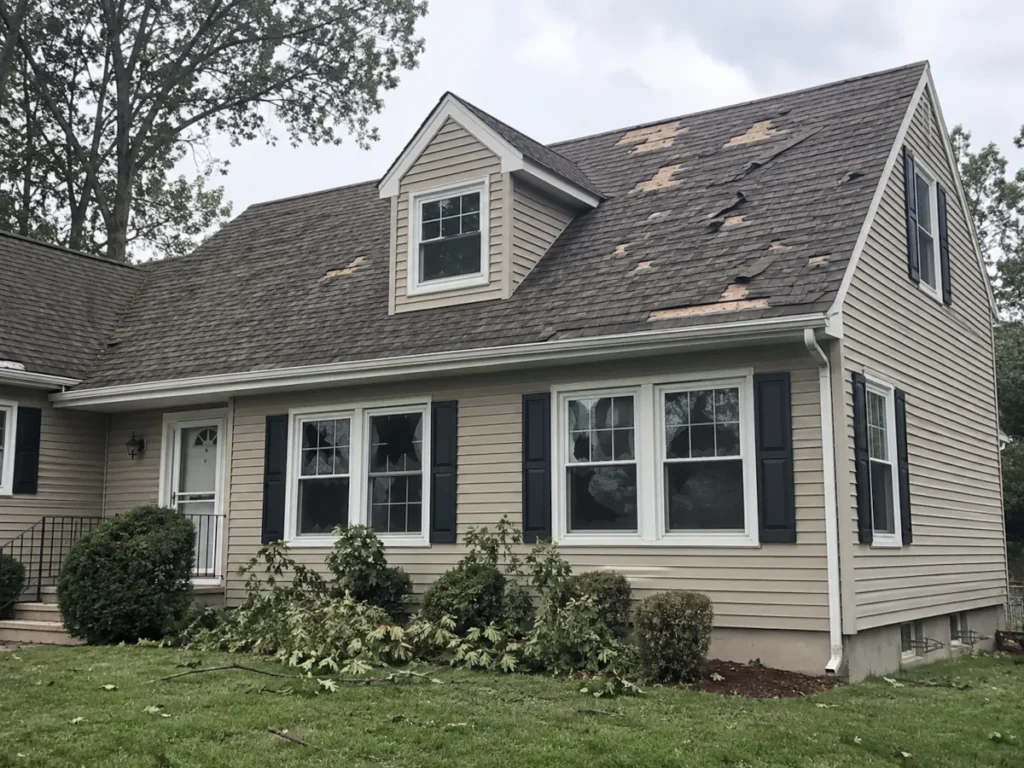 Storm damage to a residential roof and windows in Morris County, NJ
